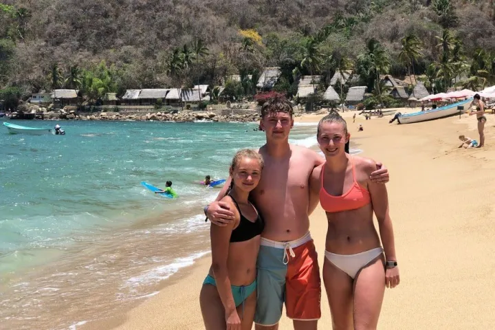 a group of people standing on a beach