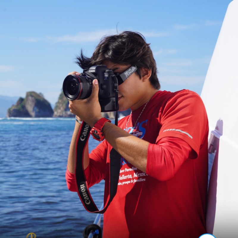 a person standing next to a body of water