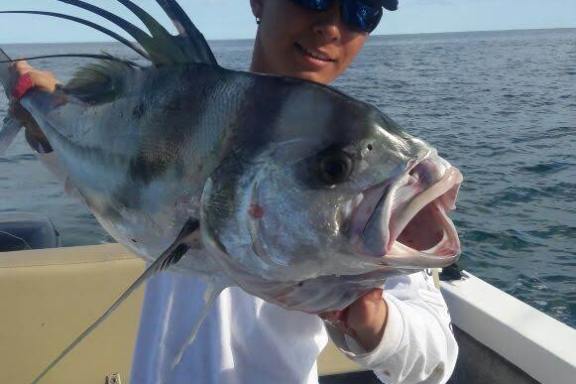 a person holding a fish in the water