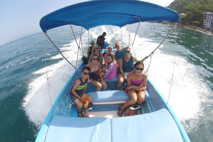 a group of people in a boat on a body of water