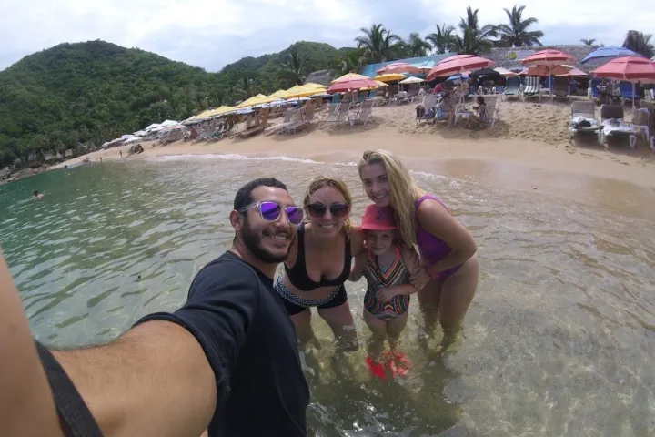 a person standing next to a body of water
