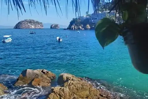a group of people on a beach near a body of water