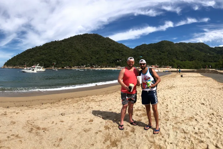 a man standing on top of a sandy beach