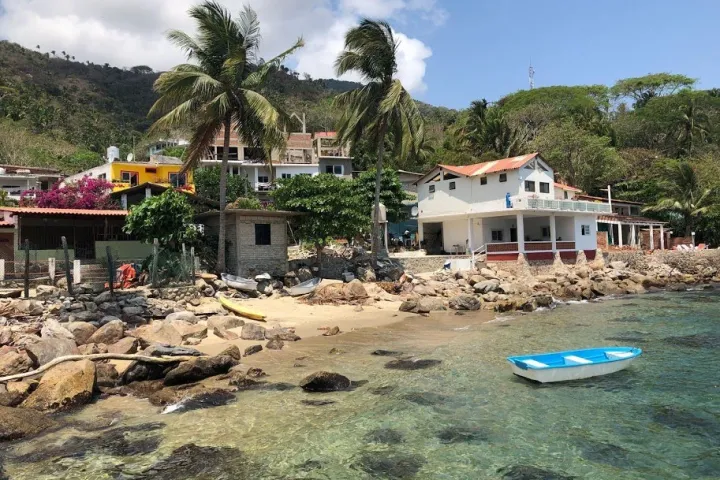 a group of lawn chairs sitting on top of a beach
