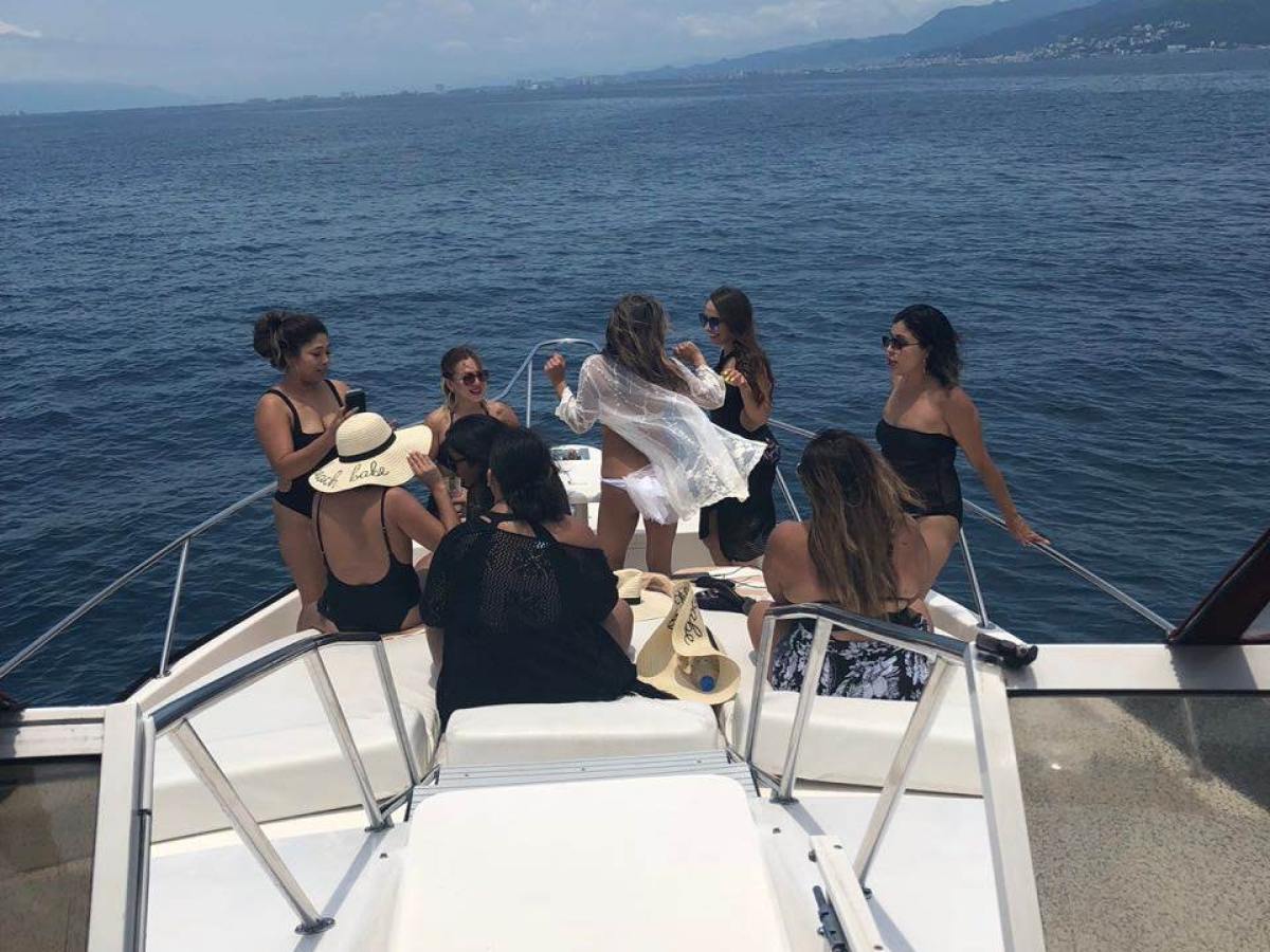 a group of people standing next to a body of water