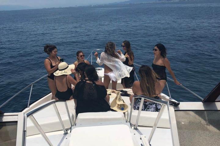 a group of people standing next to a body of water