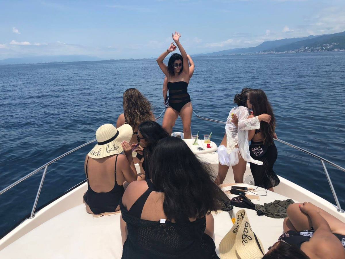 a woman sitting on a boat in a body of water