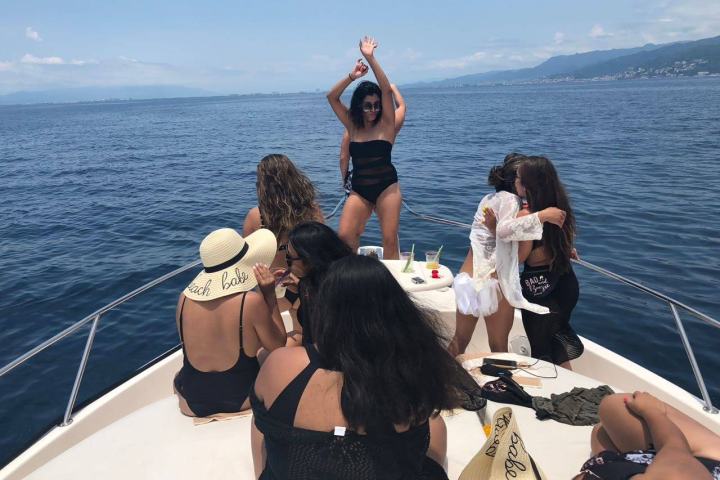 a woman sitting on a boat in a body of water