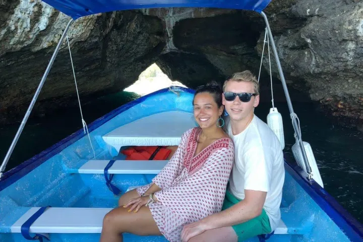 a person in a blue boat sitting next to a pool of water