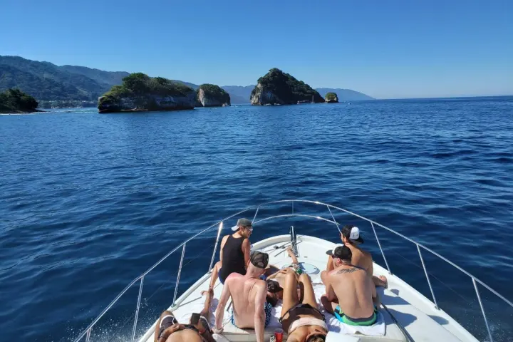a group of people in a boat on a body of water
