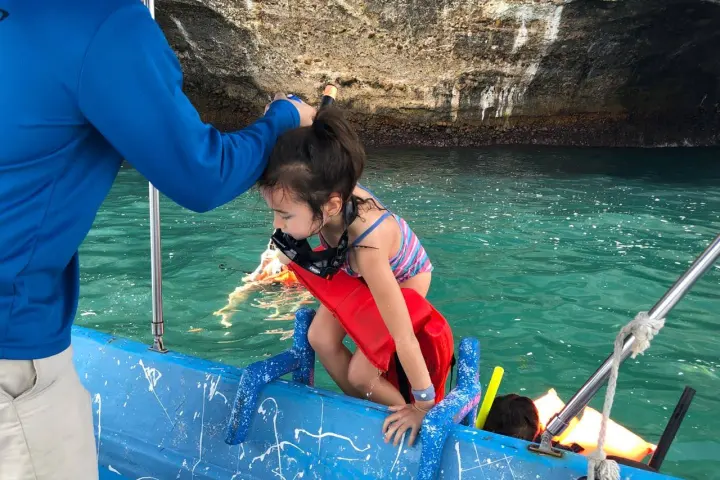 a group of people on a raft in a pool of water