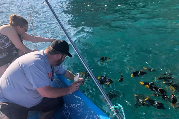 a man standing next to a body of water