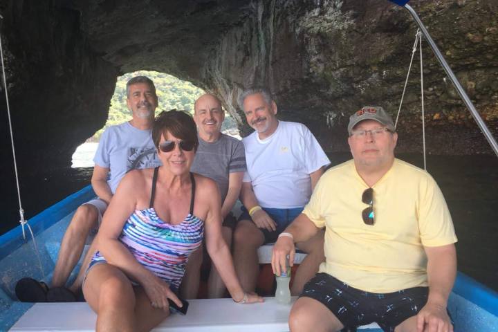 a couple of people that are sitting on a bench posing for the camera