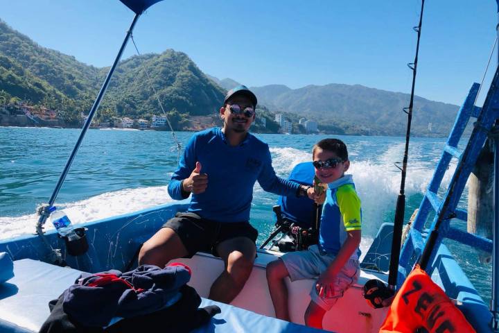 a person sitting in a boat on a body of water