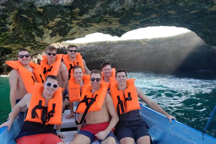 a group of people sitting next to a body of water
