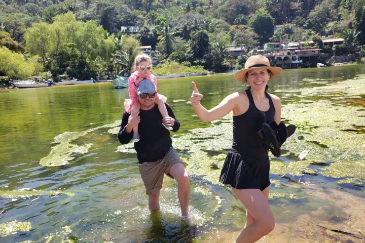 a man and a woman standing next to a body of water