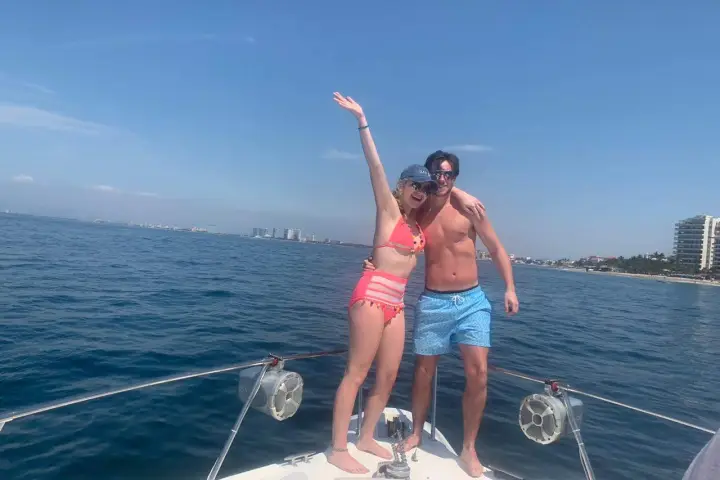 a woman standing next to a body of water