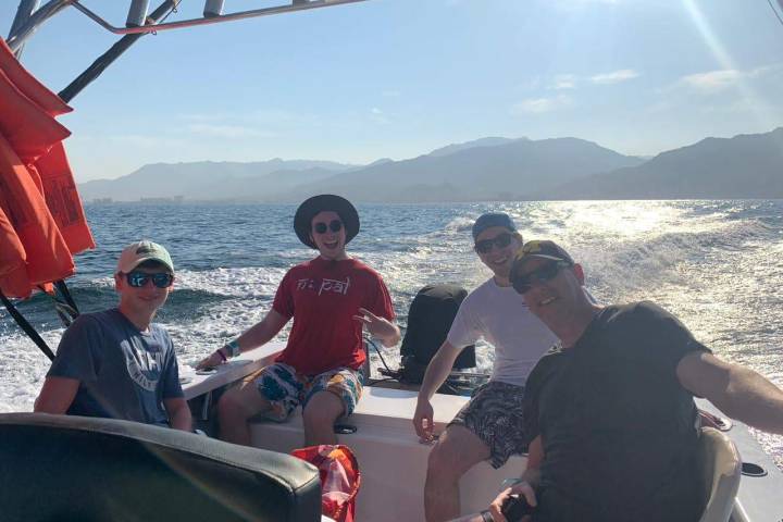 a group of people in a boat on a body of water