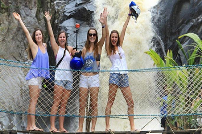 girls posing in front waterfall