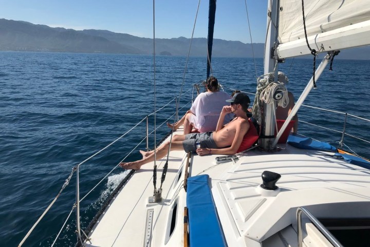a group of people in a boat on a body of water