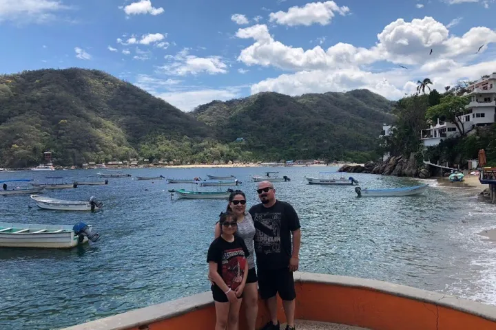a group of people standing next to a body of water