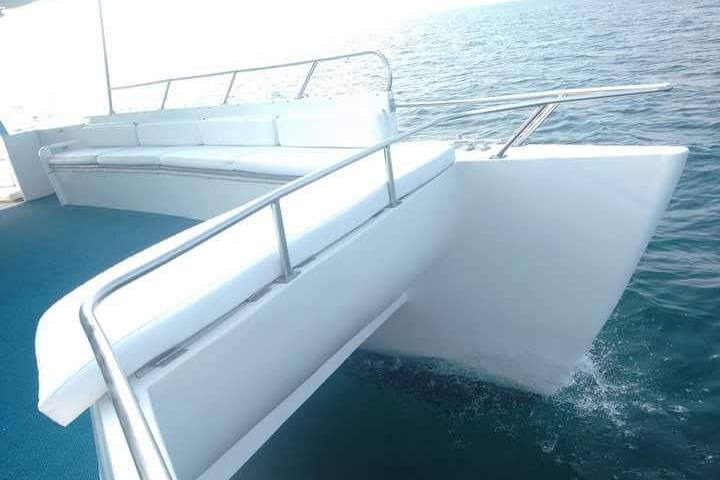 a white boat sitting next to a body of water