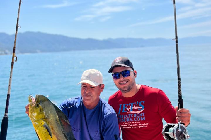a man holding a fish in the water