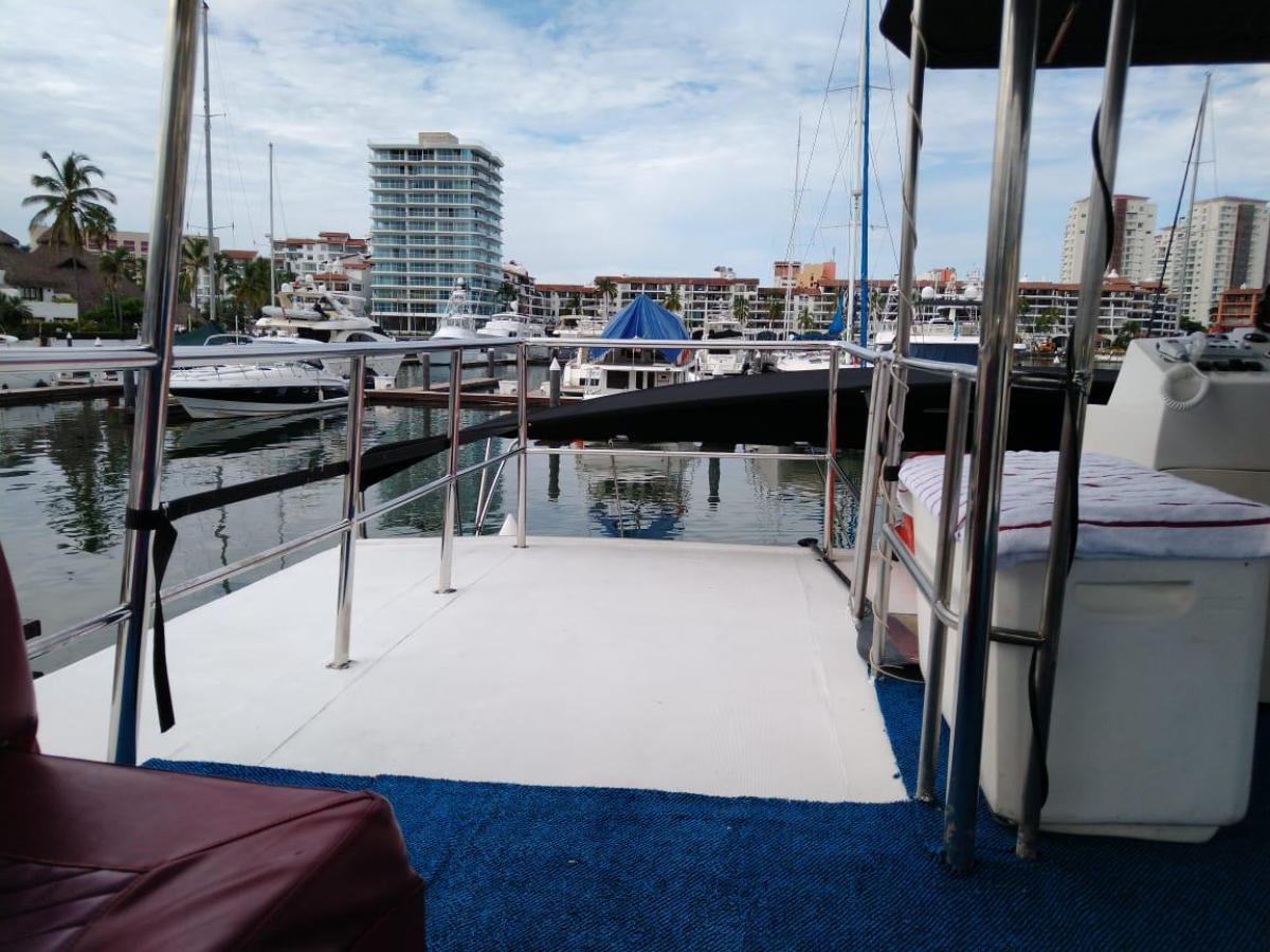 View from boat deck with marina and buildings in background.
