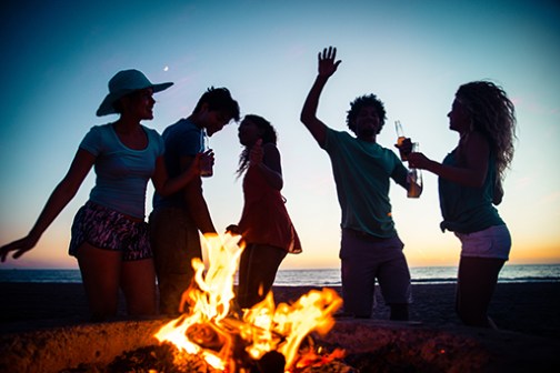 a group of people standing around a fire