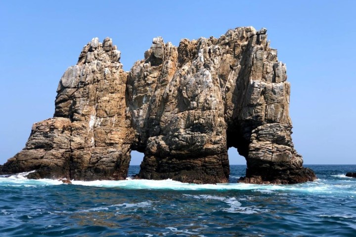 a close up of a rock near the ocean