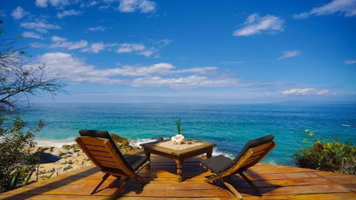 a wooden bench sitting next to a body of water