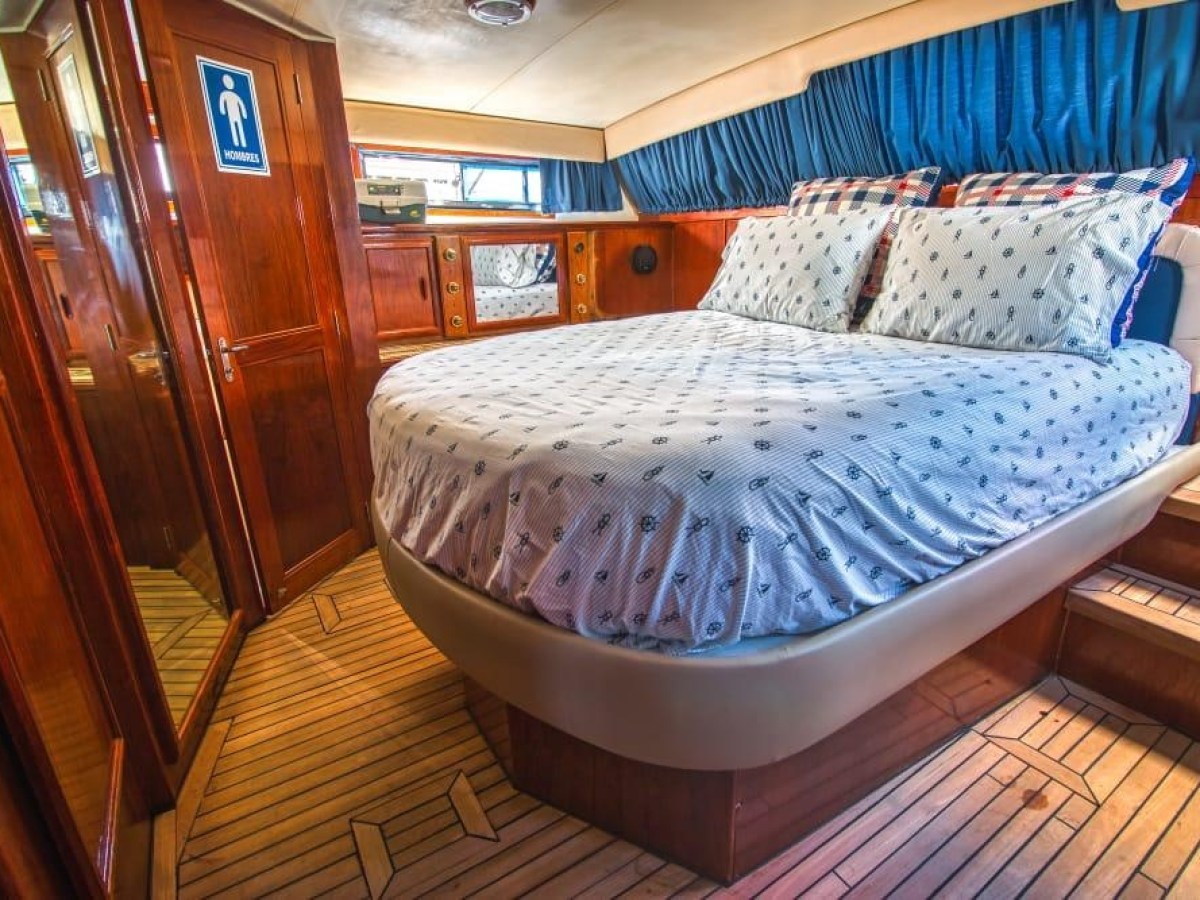 a bedroom with a bed and a chair in a room