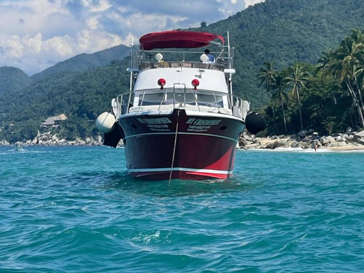 a small boat in a body of water with a mountain in the background