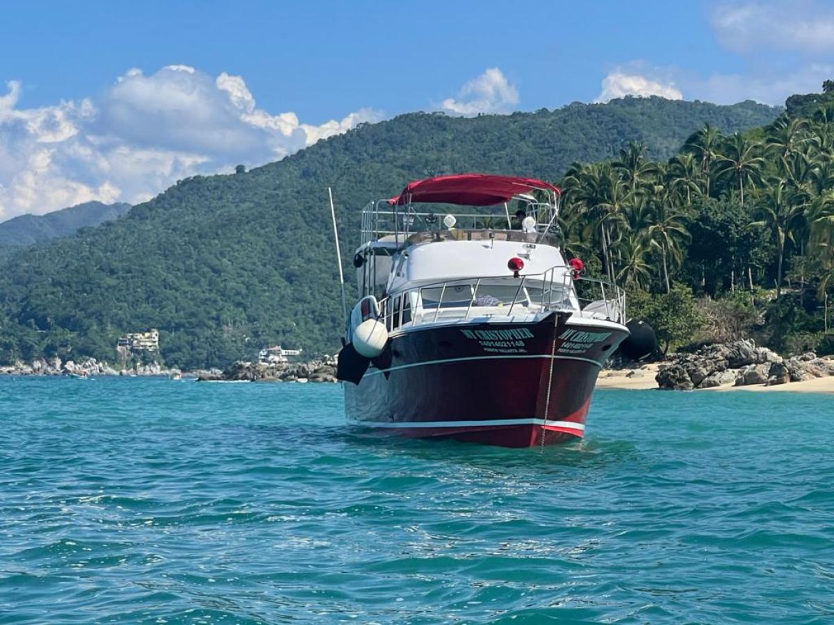 a small boat in a body of water with a mountain in the background