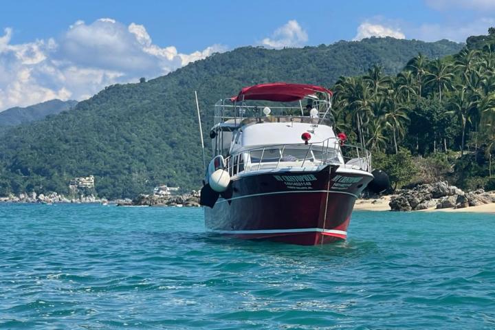 a small boat in a body of water with a mountain in the background