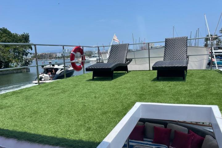 a group of lawn chairs sitting on top of a grass covered field