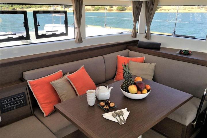 a chair sitting in front of a window with water on the table