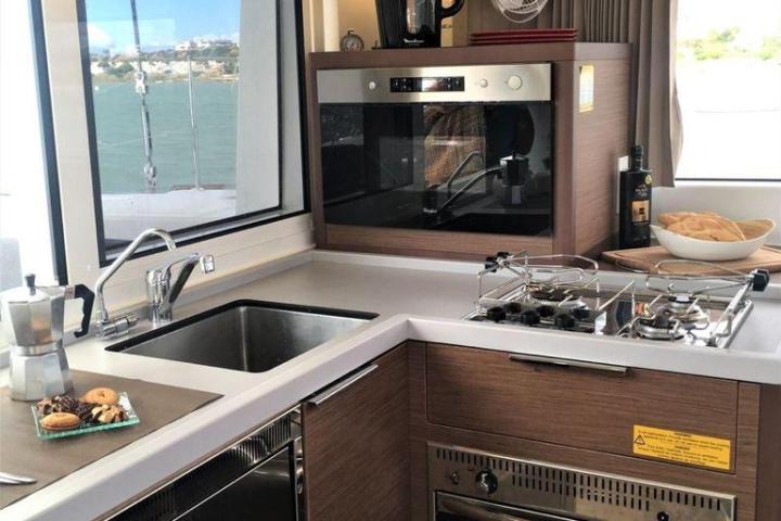 a kitchen with a stove top oven sitting next to a window