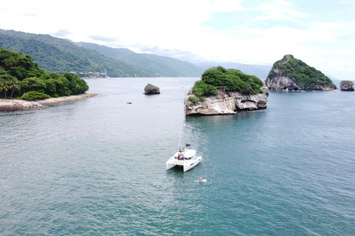 a small boat in a body of water with a mountain in the background