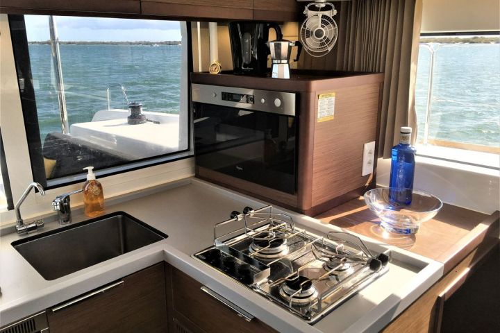 a kitchen with a stove top oven sitting next to a window