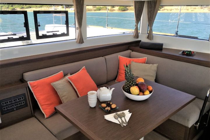 a chair sitting in front of a window with water on the table
