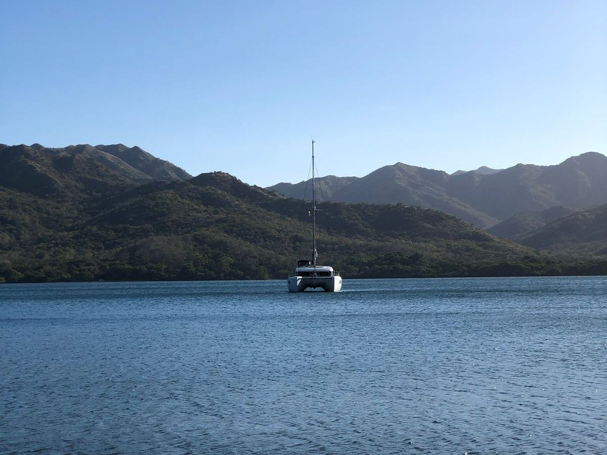 a large body of water with a mountain in the background