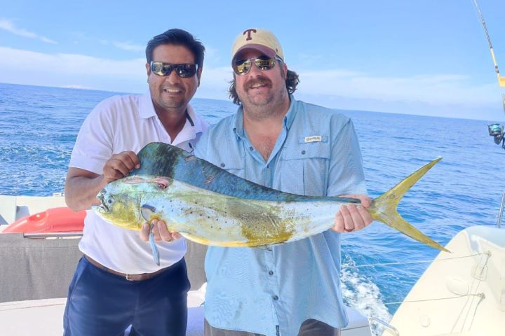a person holding a fish in the water