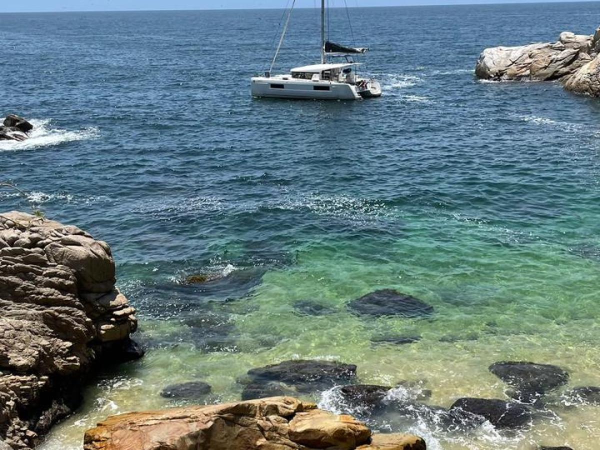 a rocky island in the middle of a body of water