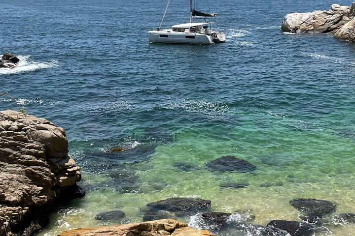 a rocky island in the middle of a body of water
