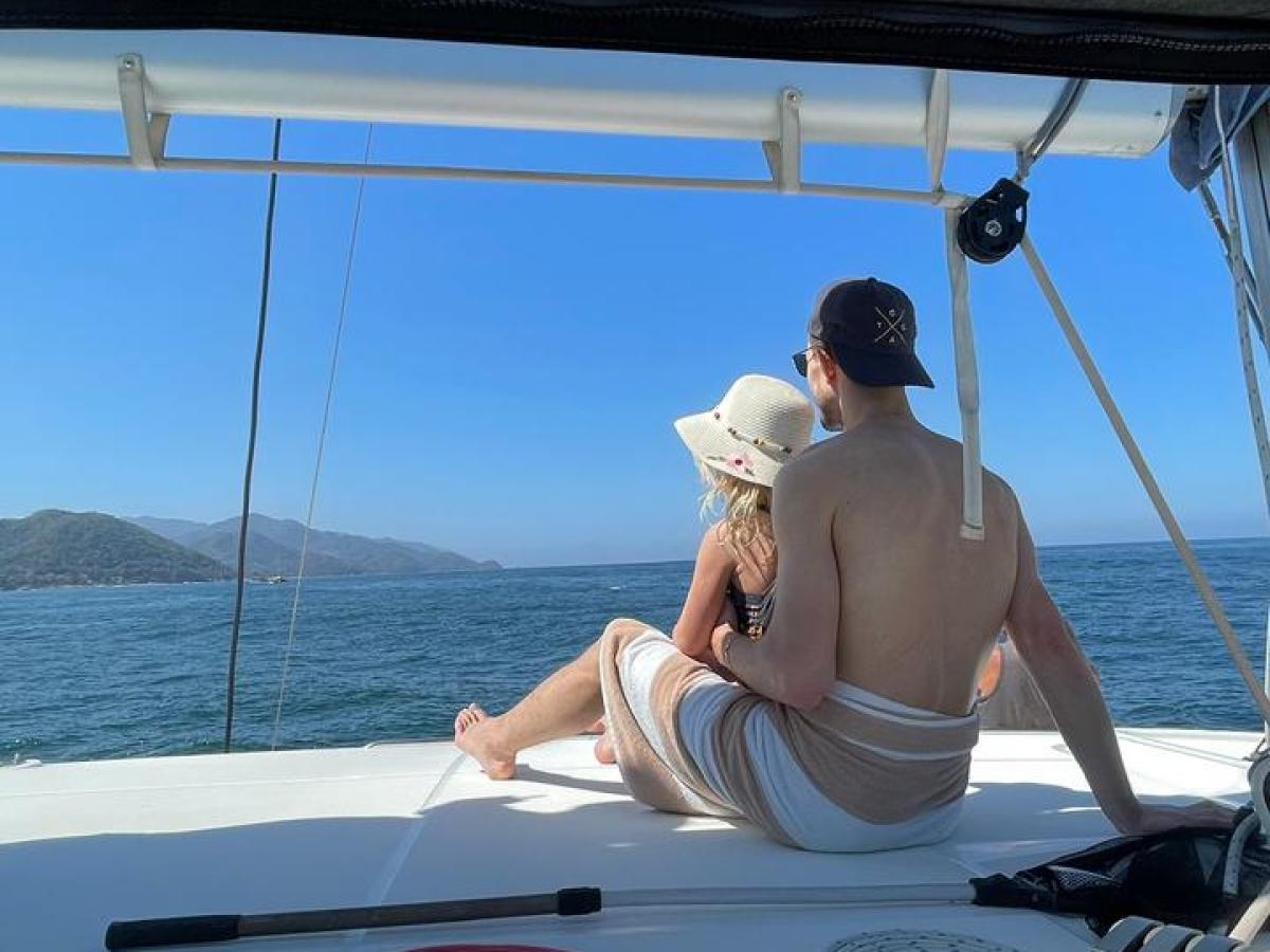 a group of people sitting on a boat in the water