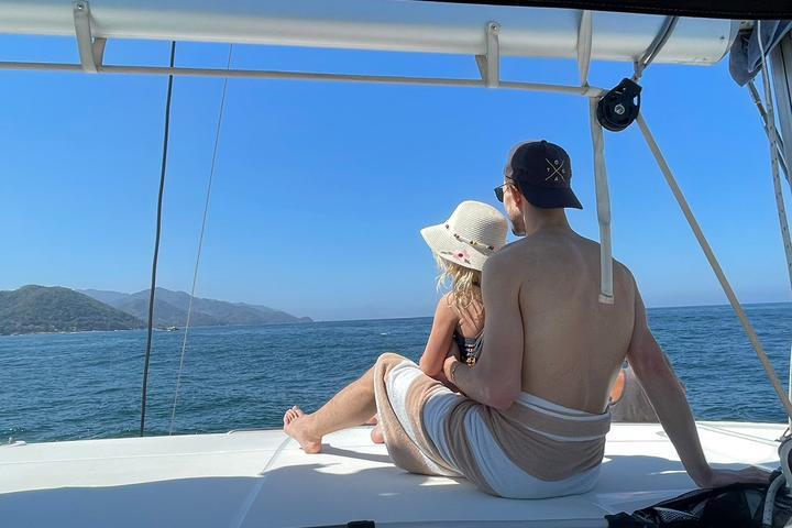 a group of people sitting on a boat in the water