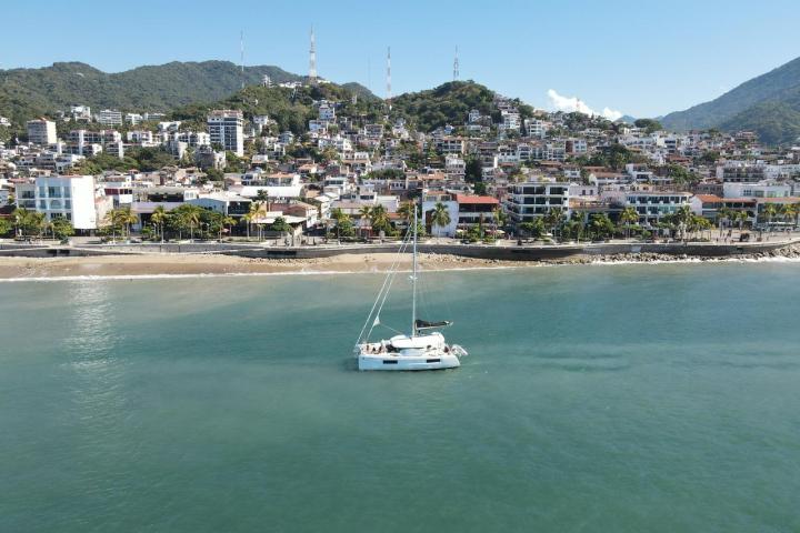 a small boat in a body of water with a city in the background