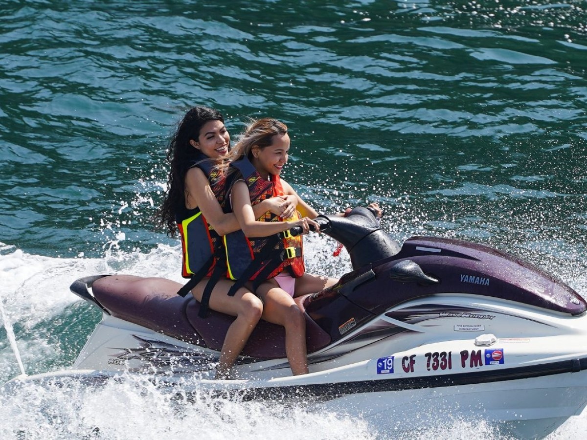 a woman riding a wave on a surfboard in the water