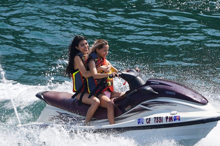 a woman riding a wave on a surfboard in the water